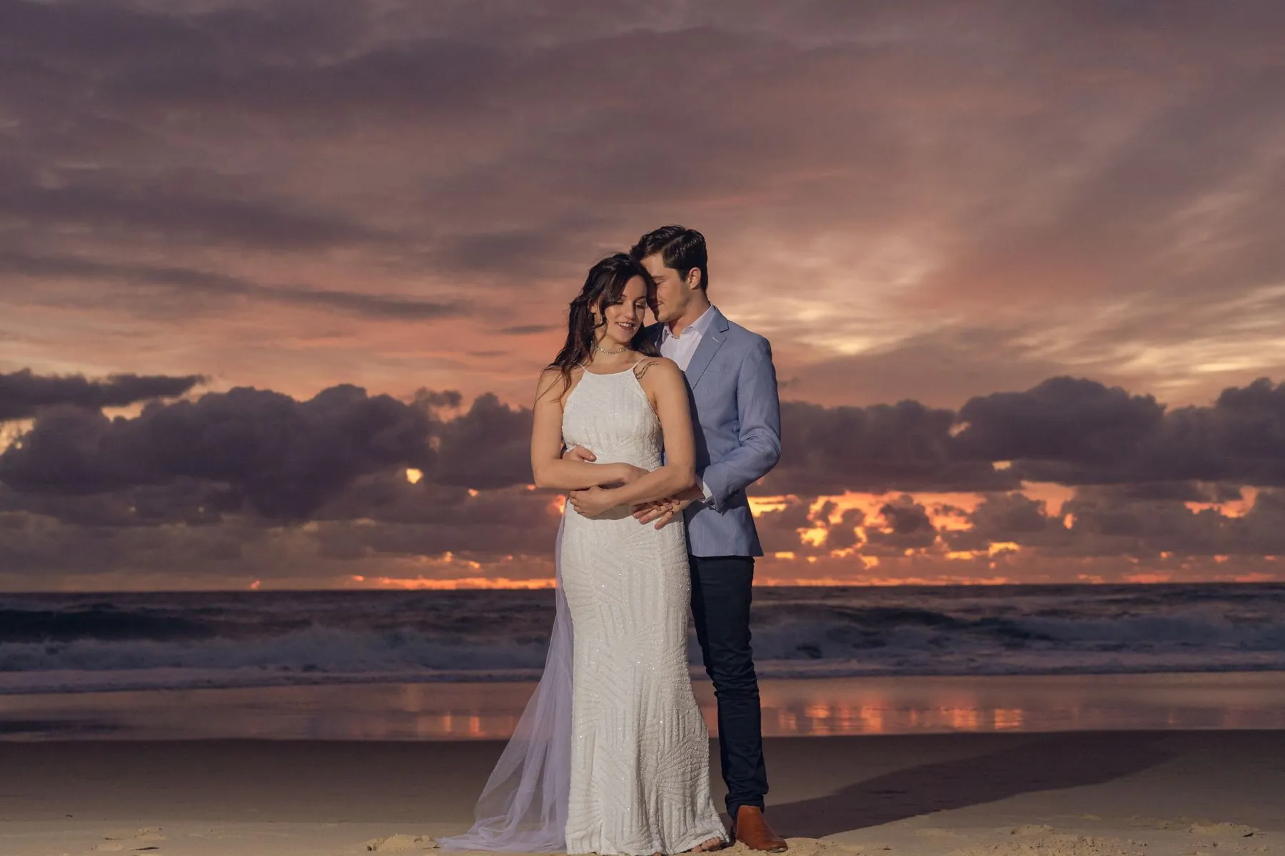 Beach wedding embrace at sunset