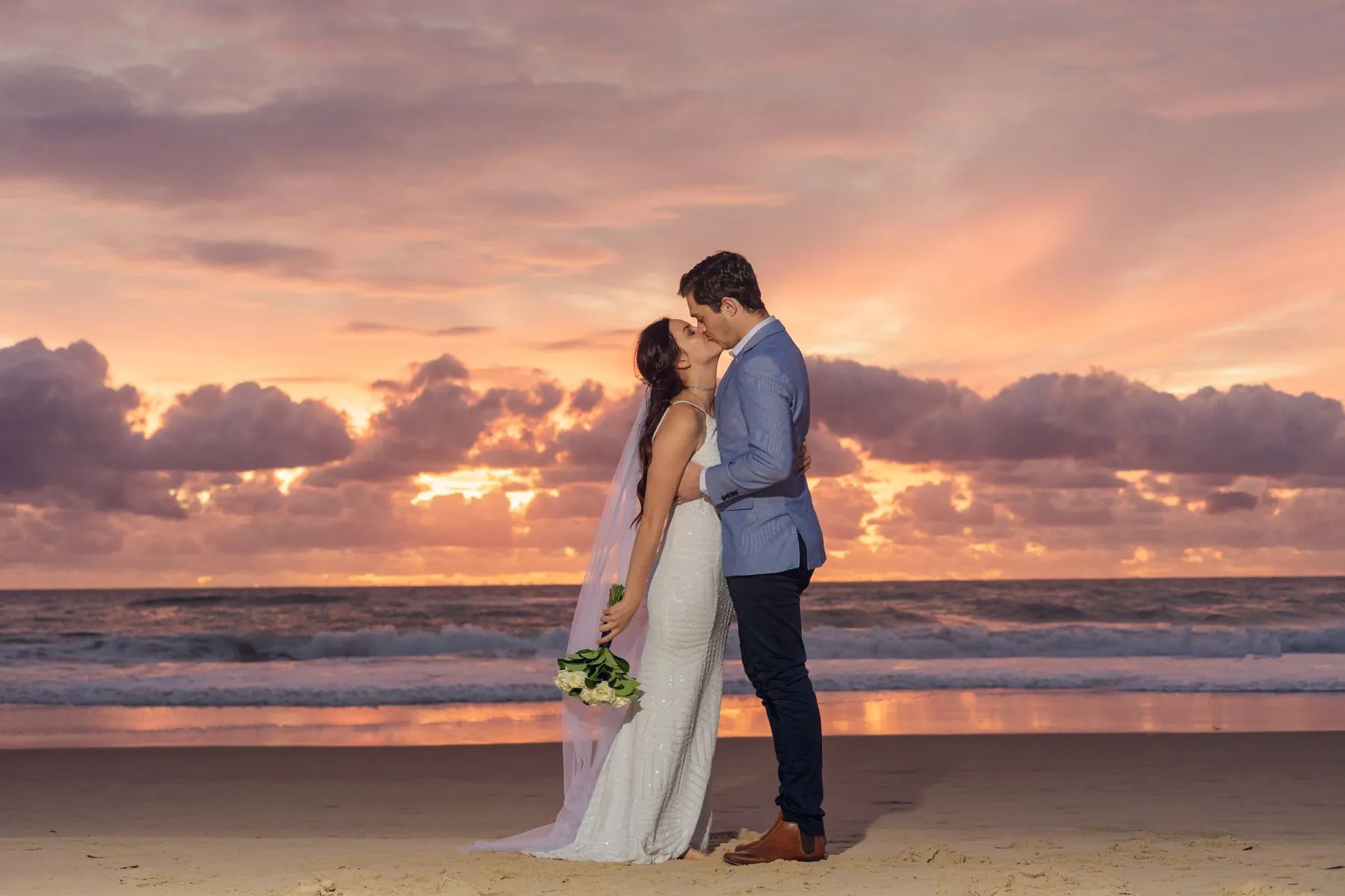 Bride laughing during a beach wedding