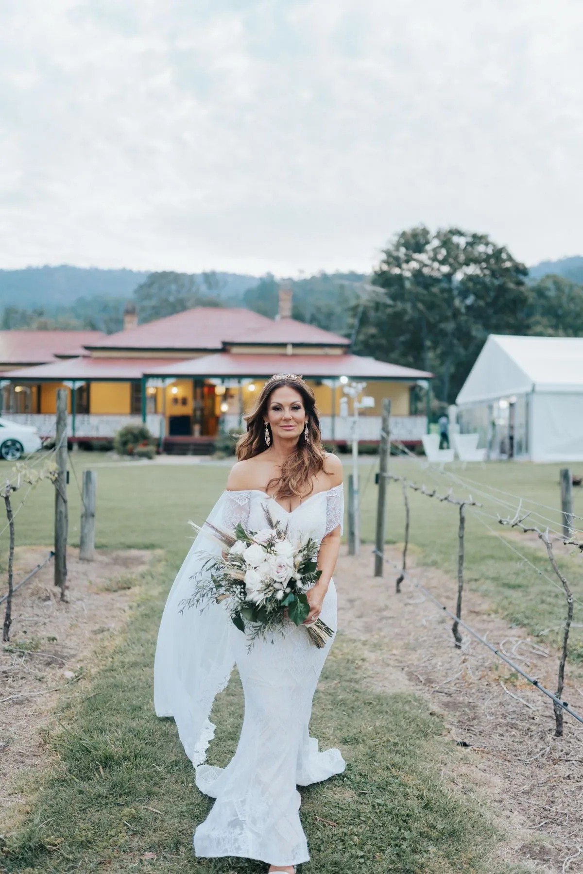 Bride walking through a vineyard