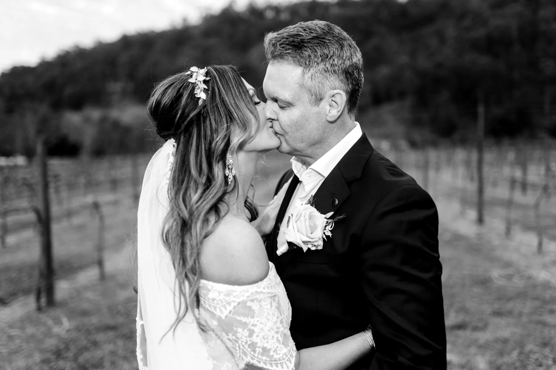 Black and white vineyard wedding kiss